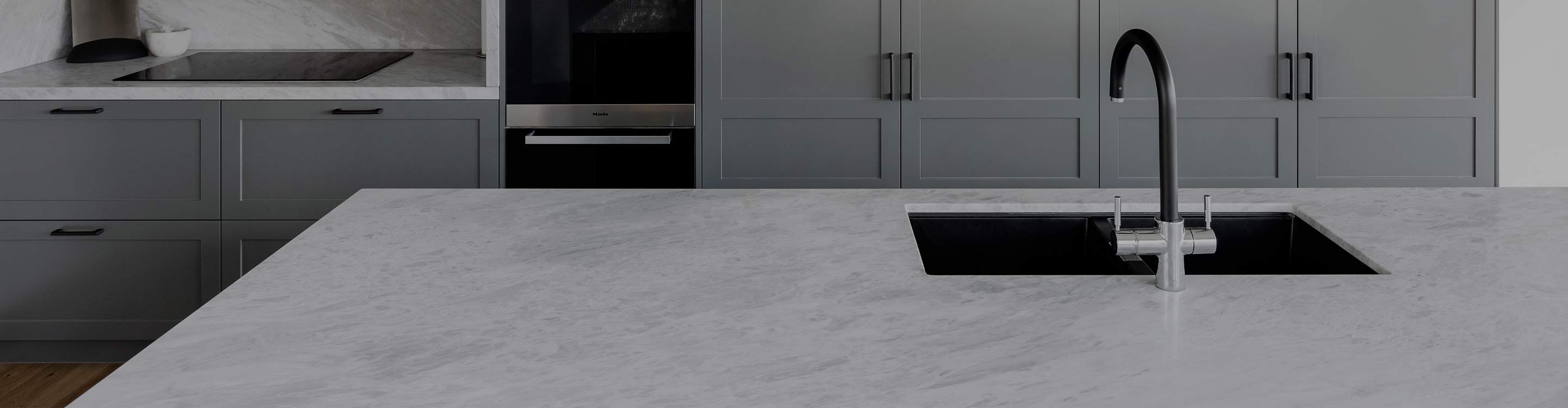 quartz white countertops in modern kitchen with gray cabinetry