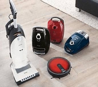 vacuums in a variety of colors on wood floor