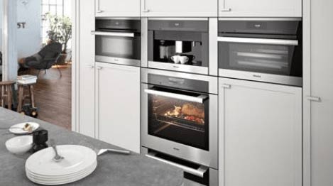 kitchen room scene with white countertops and silver oven